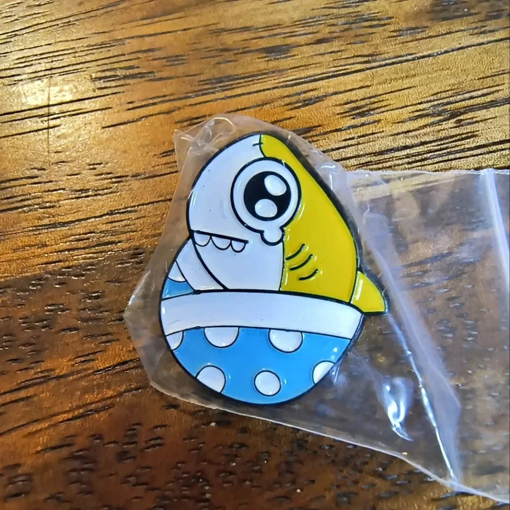 Yellow white cartoon shark in egg enamel pin backpack clothes hat bag denim cap